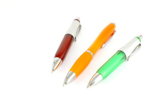 Brown, green and orange pen over white