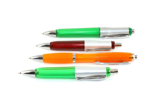 Brown, green and orange pen over white