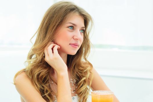 Portrait of a cute woman in a city cafe