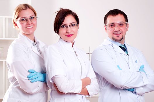 three doctors standing in a row with his arms crossed on his chest