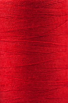 Macro view of red thread wound on a spool