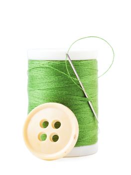 Single spool with green thread and needle