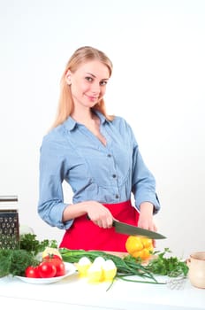 beautiful woman cuts vegetables