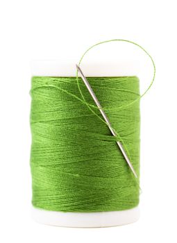Single spool with green thread and needle