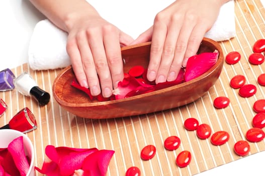 female hands in the bath with rose petals