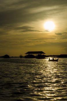 sunset over a floating village