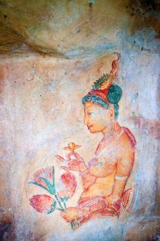 Ancient famous paintings (frescoes) on stone wall at Sigirya Sri Lanka
