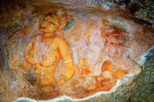 Ancient famous paintings (frescoes) on stone wall at Sigirya Sri Lanka