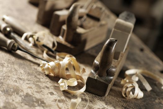 Wood planer and shavings at carpenters workshop