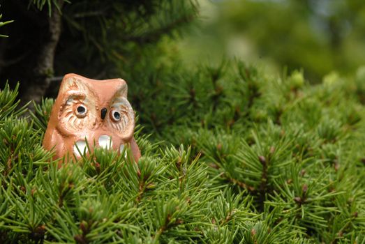 toy owl in a tree with copy space