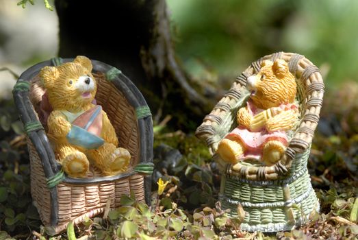 baby boy and girl teddy bears sitting on the countryside