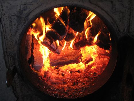 Fire wood brighly burning in the furnace