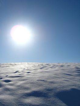 Winter solar landscape with bright snow on the sun