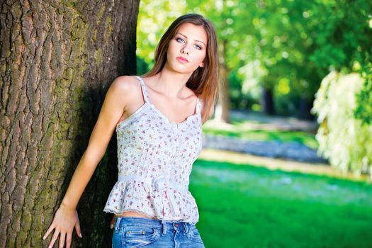 Cute brunette woman on sunny day in park, outdoor
