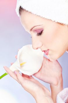 pretty woman with towel on head holding flower