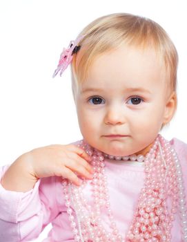Portrait of an adorable baby girl wearing a pink with pearl necklace