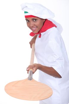 female pizza cook using a spade