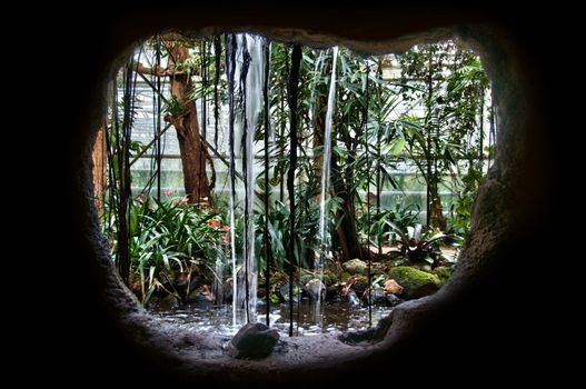 view behind the waterfall in a indoor nature park