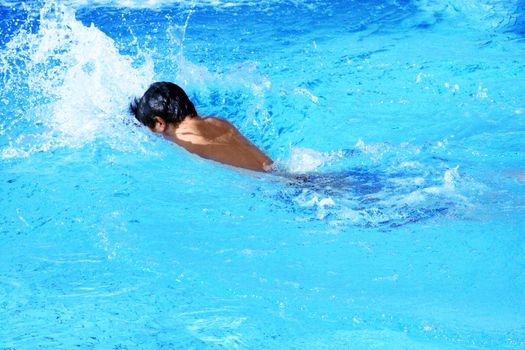 man swims in swimming pool