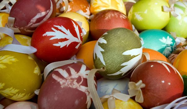 Various Easter eggs on a one heap with ribbon