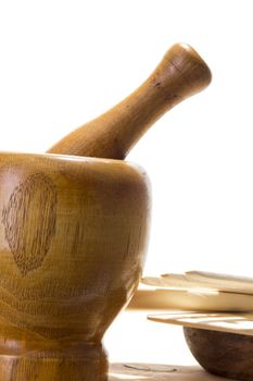 Wooden mortar and pestle on white background. Traditional kitchen equipment.