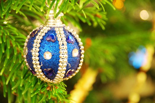 Beautiful blue decoration is hanging on a christmas tree. Shallow DOF