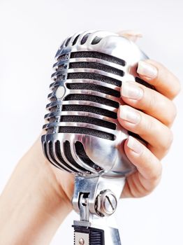 Big retro microphone in woman's hand