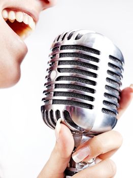 woman holding big retro microphone for singing