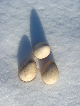 Landscape with three eggs lying of turkey on the snow