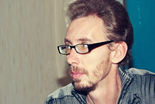 Closeup portrait of handsome young adult wearing glasses