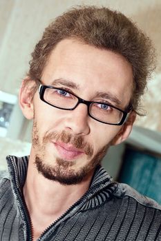 Closeup portrait of handsome young adult wearing glasses