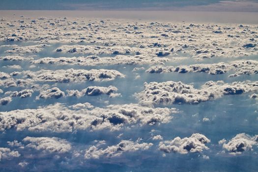 Beautiful clouds forming a mystical and dreamy cloudscape 30000 feet in the air