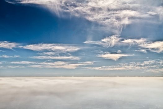 Beautiful clouds forming a mystical and dreamy cloudscape 30000 feet in the air