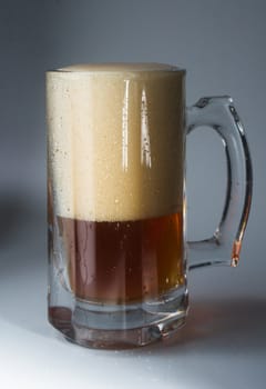 Beer glass full of cold dark beer. Isolated
