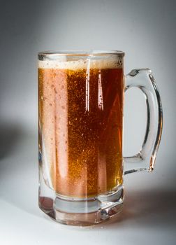Beer glass full of cold dark beer. Isolated