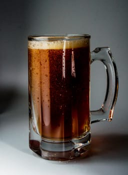 Beer glass full of cold dark beer. Isolated