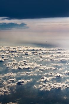 Beautiful clouds forming a mystical and dreamy cloudscape 30000 feet in the air