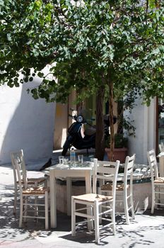 Cozy greek taverna with tables outside in the yard