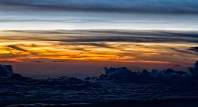 Beautiful clouds forming a mystical and dreamy cloudscape 30000 feet in the air