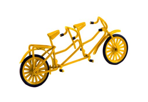 Double yellow color bicycle toy isolated on white background. Small object decor.
