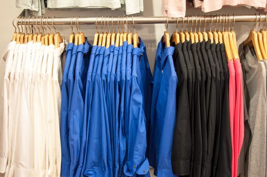 fashion clothing on hangers for display in the shop