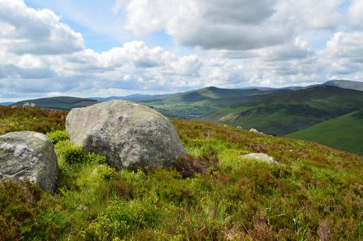 Big rocks in a typical green Irish landscape in Wicklow Mountains national park, south of Dublin in Ireland.