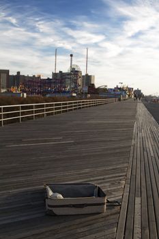 Open suitcase left on the board walk of Coney Island