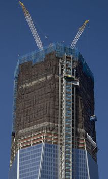 Freedom tower under construction against a blue sky