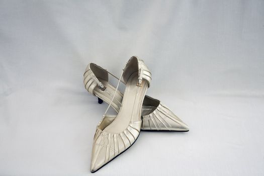 A pair of woman's silver shoes