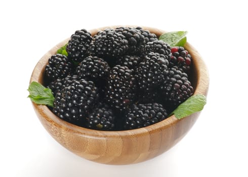Perfect Ripe Blackberries in Wooden Bowl isolated on white background