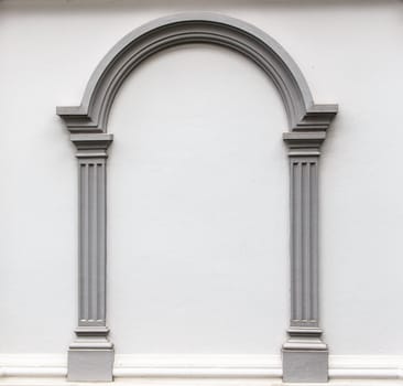 Arch molding decorates on the plain concrete wall.