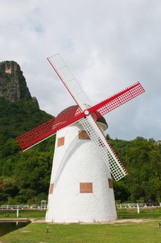 red vintage wind mill in the park 
