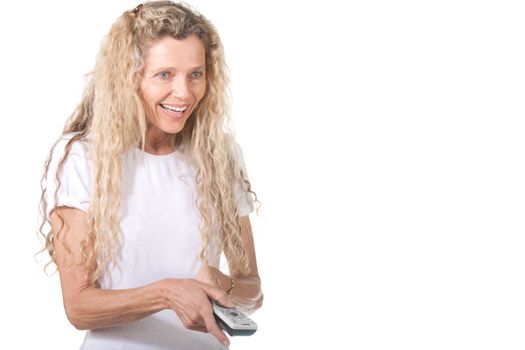 Mature woman with TV remote control smiling