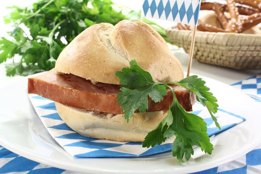 Roll with beef and pork loaf, parsley, Bavarian flag, napkin on a light background